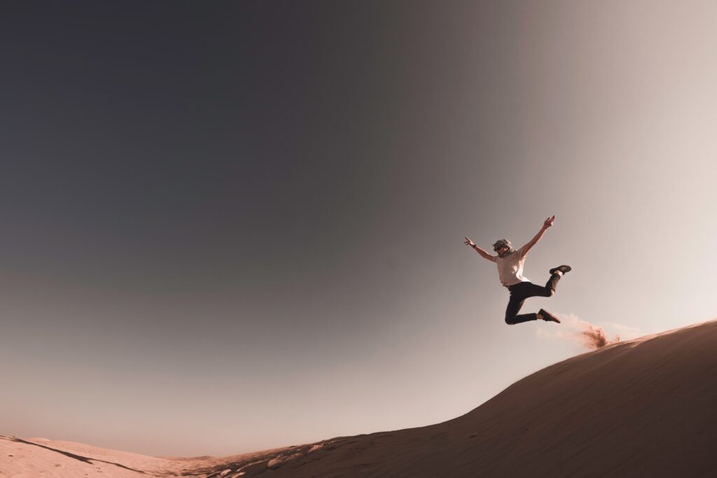 Man jumping into a pile of sand, illustrating the Jumping to Conclusions thinking traps.