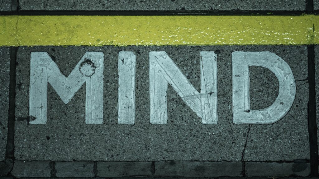 The word "mind" written on the ground, symbolizing the Mind Reading thinking traps.