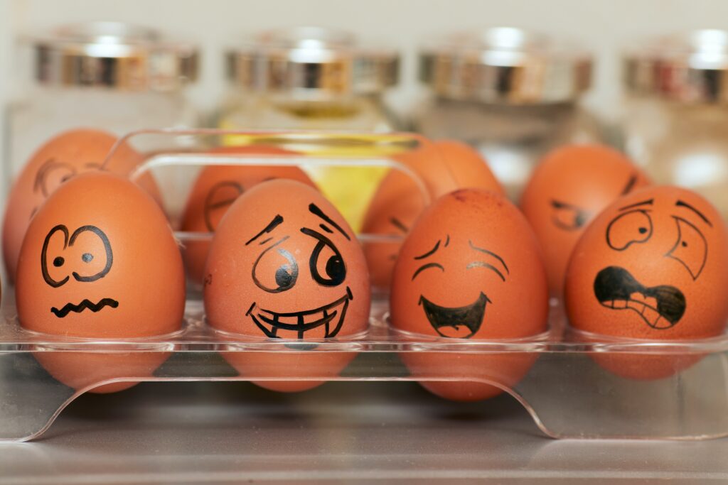 A cluster of eggs with painted faces exemplifying emotional intelligence. 